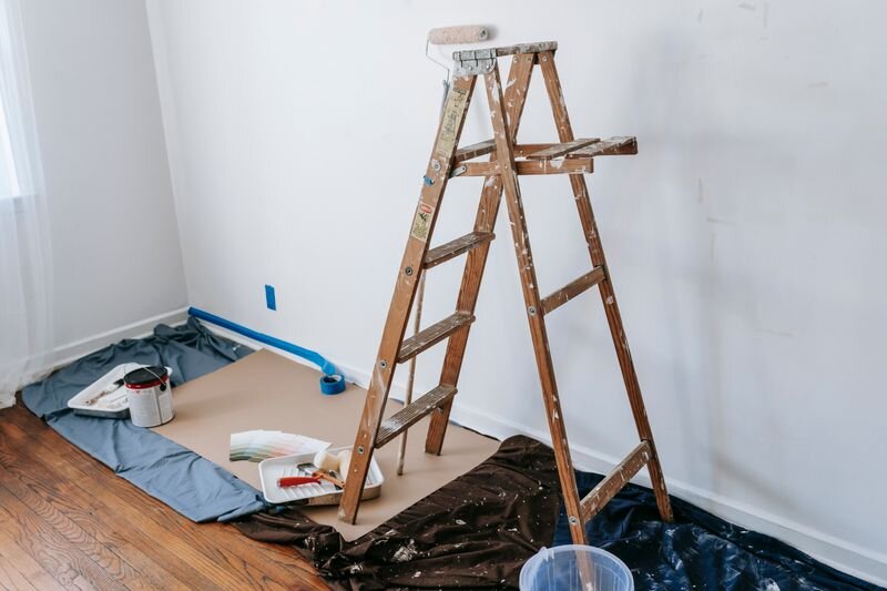 Room renovation with a ladder and painting supplies